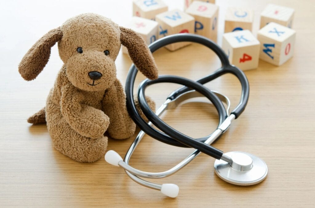 A stuffed toy and blocks near a stethoscope