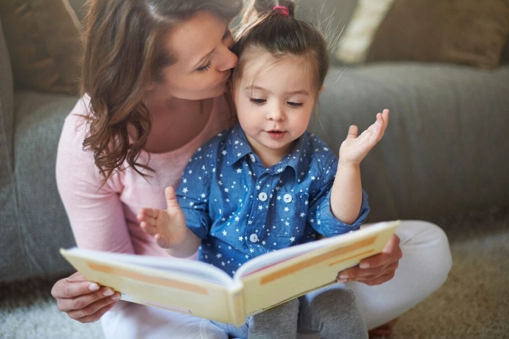 A mom reading a book to her daughter