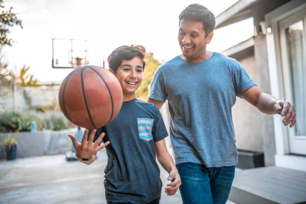 A father and son playing basketball