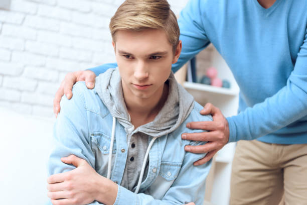 A young man being comforted