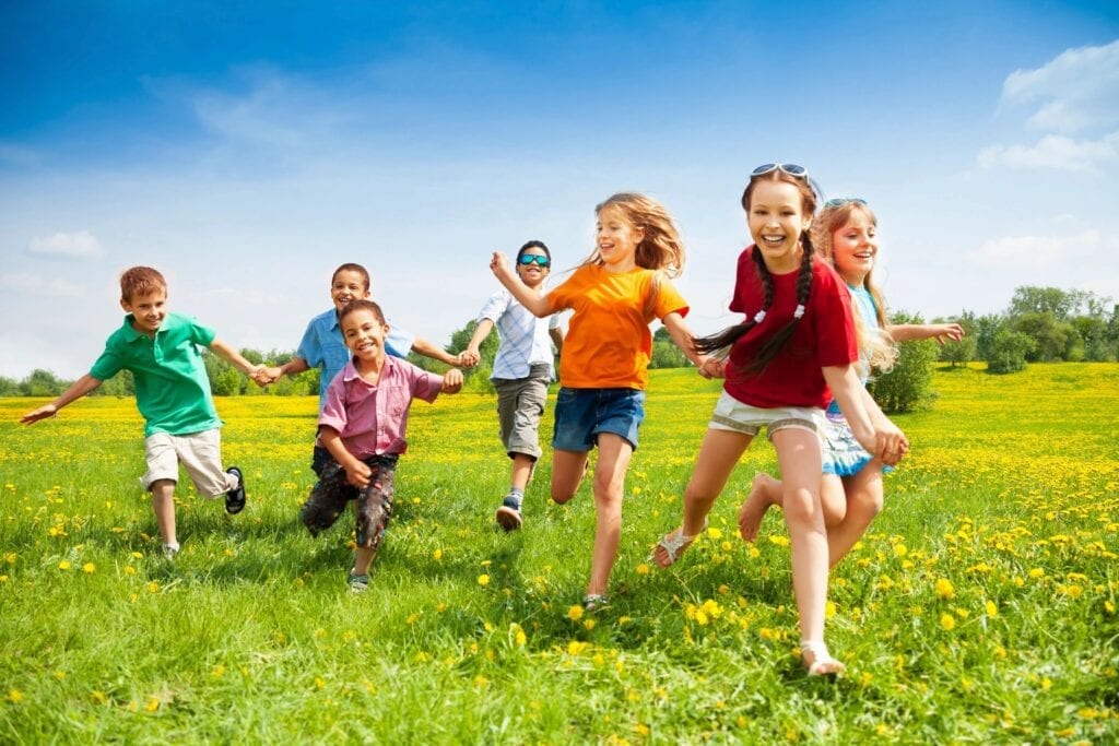 A group of kids running on grass