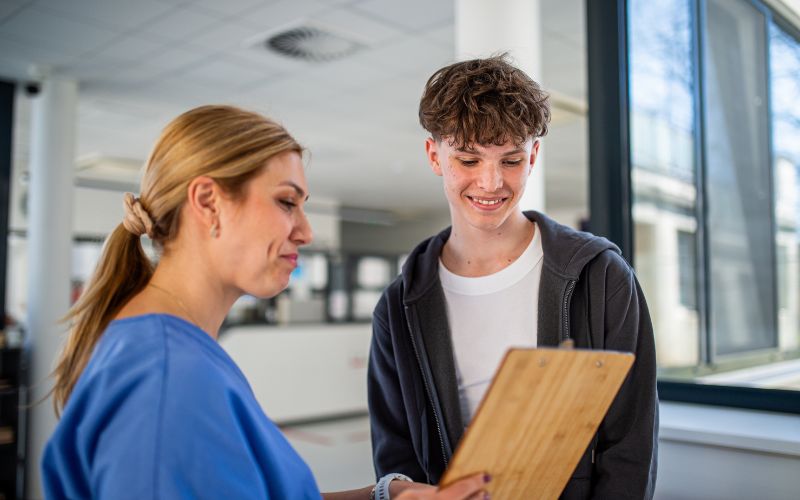 Female doctor seeing a teenage boy