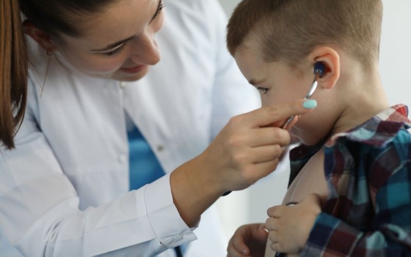 Female pediatrician checking a child