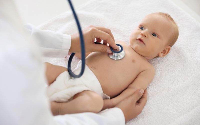 Pediatrician examining a baby.