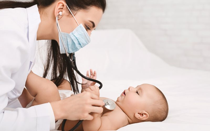 pediatrician examining lungs