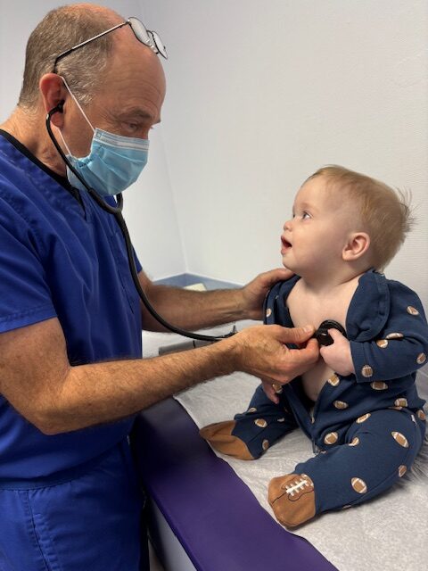 Doctor John R Porter with a child