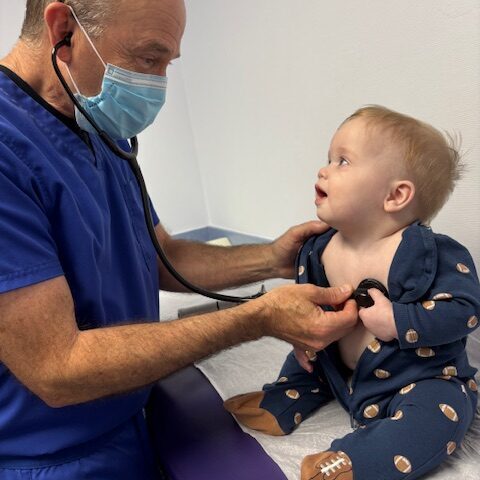 Doctor John R Porter with a child