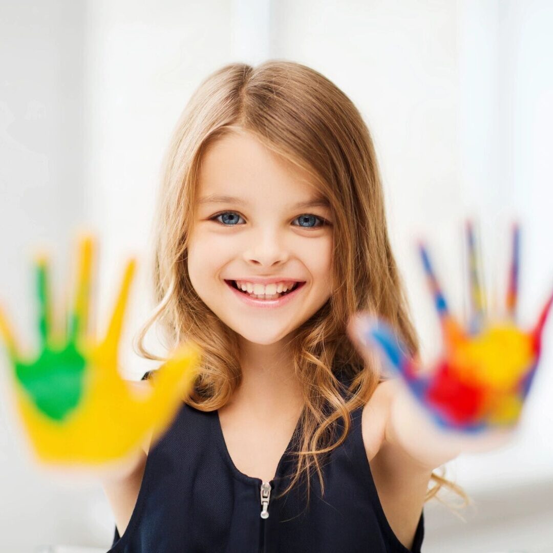 A girl with colorful hands