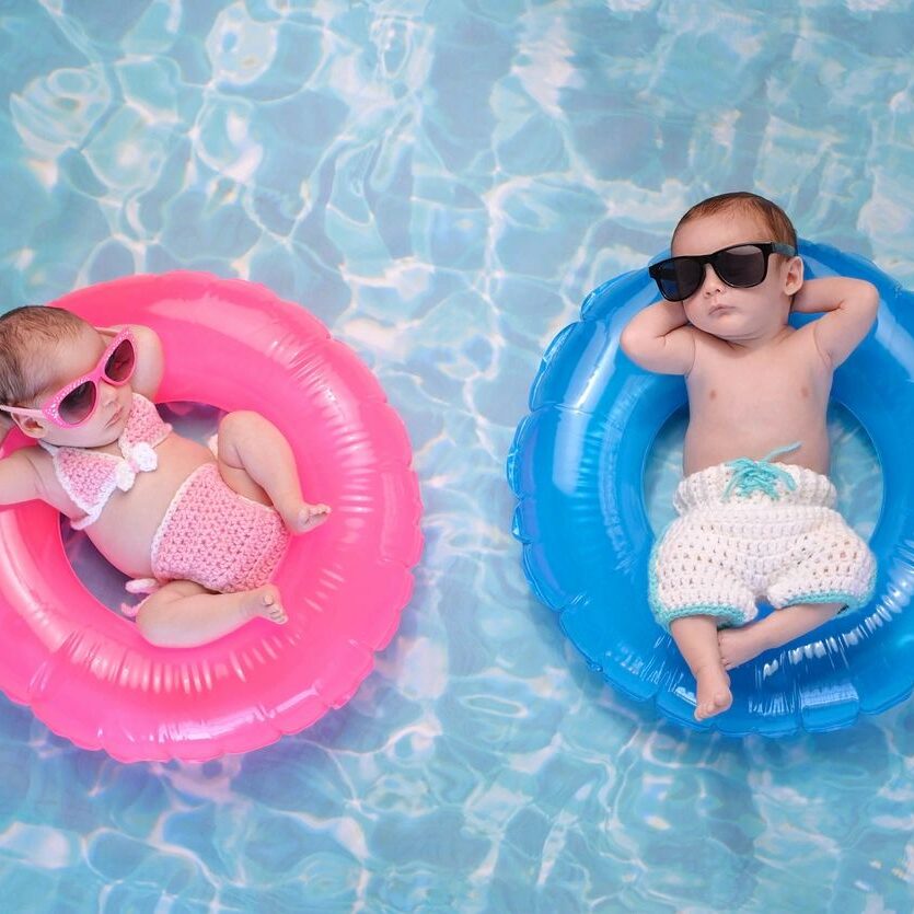 Two babies floating in a pool